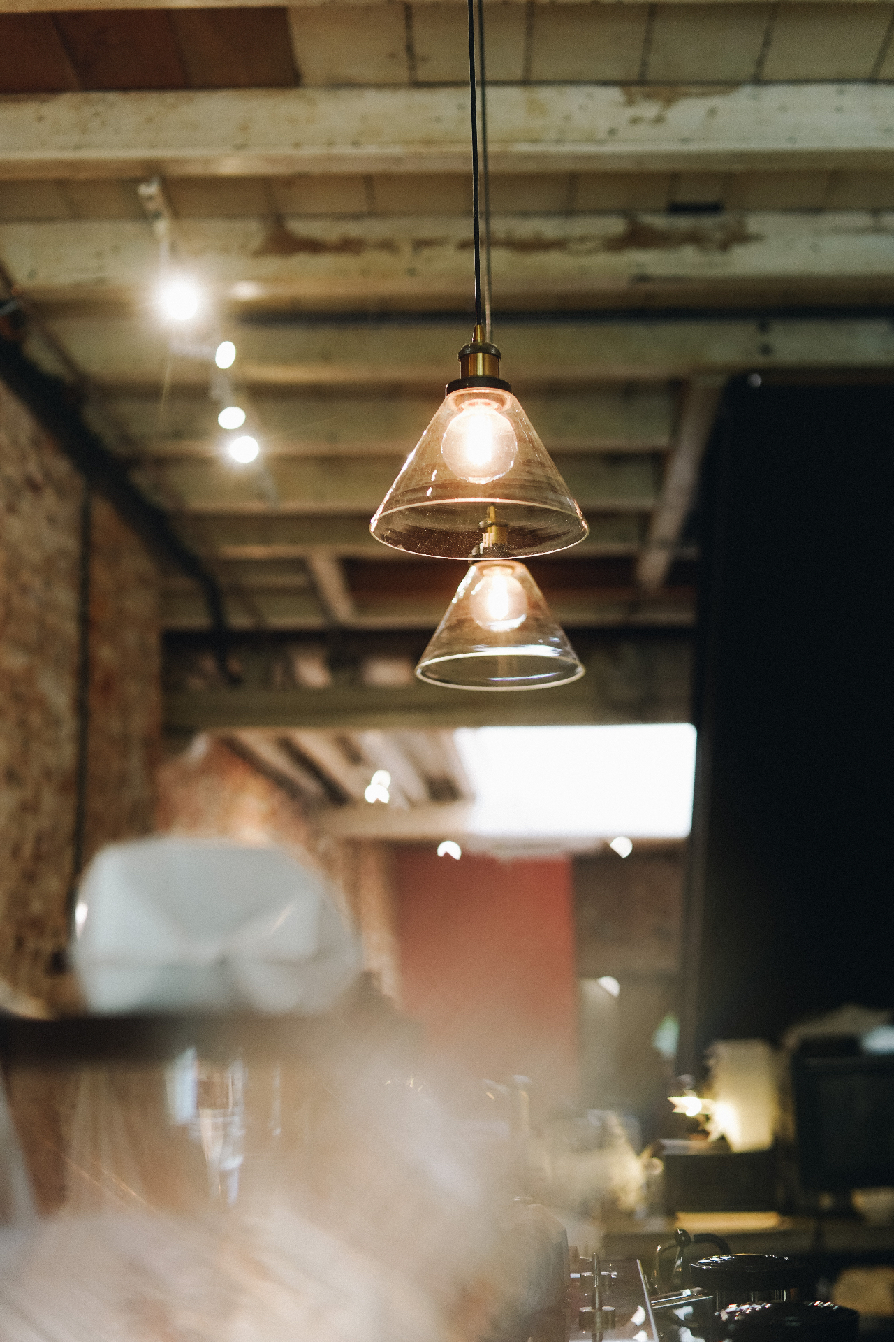 Glass pendant lights glowing above the Ome coffee bar